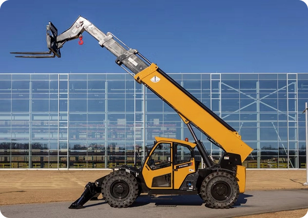 Telehandler with extended reach lifting materials outdoors